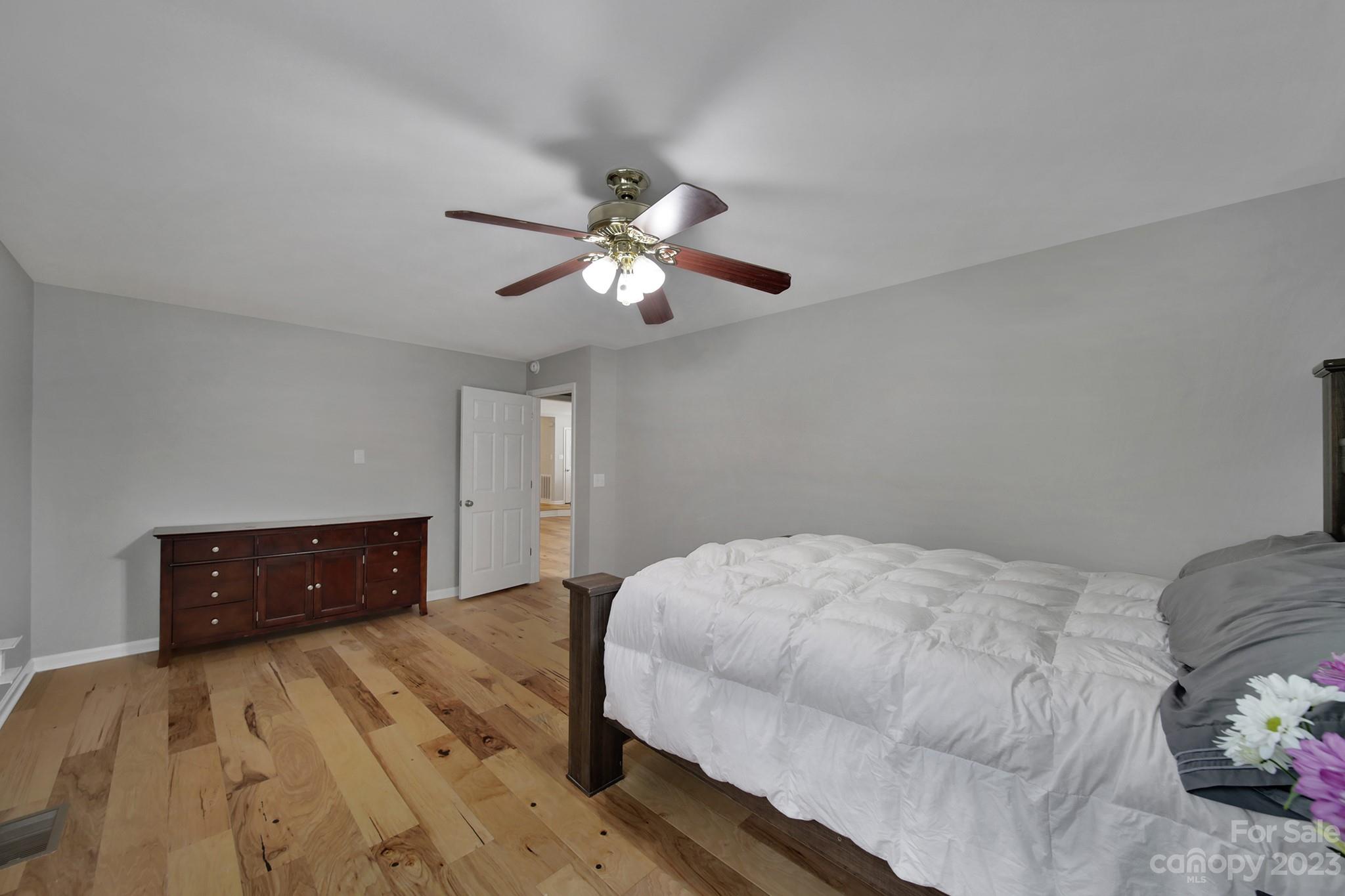 1699 Willowbrook Drive Fort Mill, SC 29708 - Photo 26 of 40 a bedroom with a bed and a chandelier