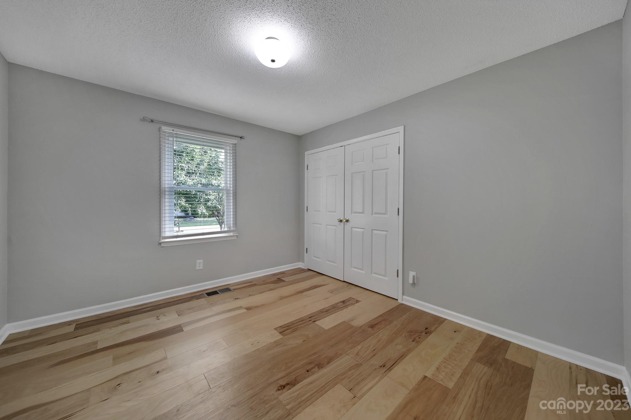 1699 Willowbrook Drive Fort Mill, SC 29708 - Photo 29 of 40 an empty room with wooden floor and windows