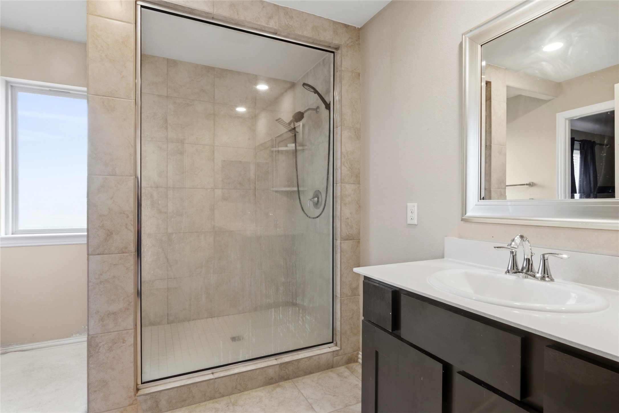 1815 Ryon Falls Drive Richmond, TX 77469 - Photo 17 of 24 a bathroom with a shower sink and mirror