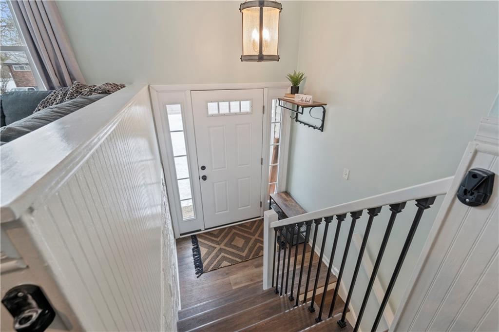 10 Rolling Road Cranberry Township, PA 16066 - Photo 3 of 39 The spacious and inviting entry features an updated chandelier, luxury vinyl plank flooring, crisp white paint, and stylish wrought iron spindles.
