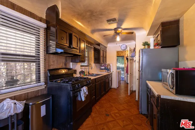 a kitchen with stainless steel appliances granite countertop a stove a sink dishwasher and a refrigerator