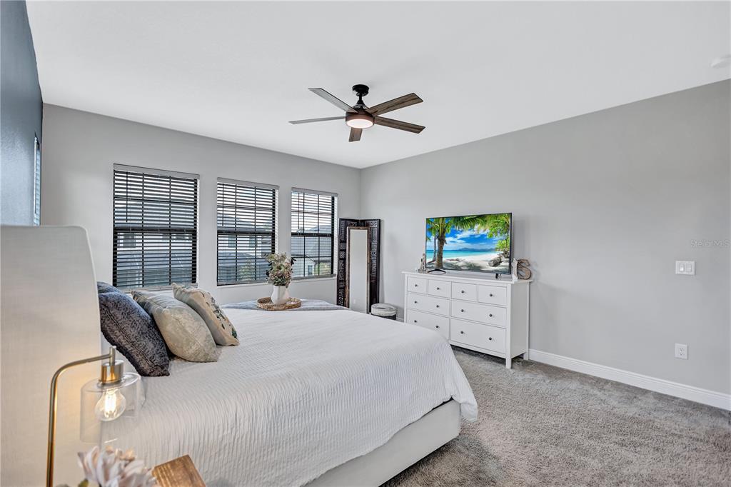 4593 Shoreleaf Loop Valrico, FL 33596 - Photo 12 of 39 a bedroom with a balcony a bed and a flat screen tv