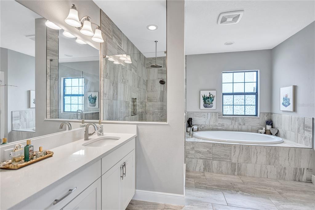 4593 Shoreleaf Loop Valrico, FL 33596 - Photo 13 of 39 a spacious bathroom with sinks mirror and a bathtub