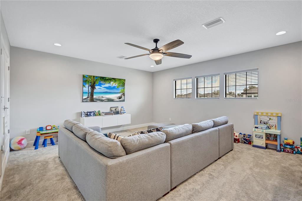 4593 Shoreleaf Loop Valrico, FL 33596 - Photo 18 of 39 a living room with furniture and a ceiling fan