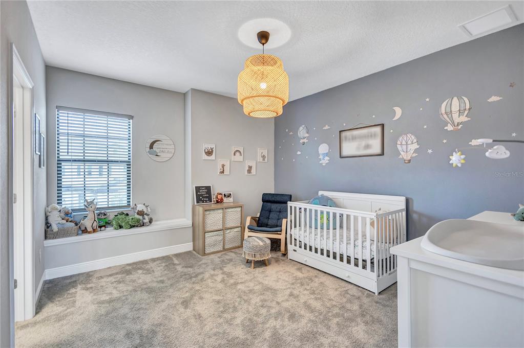 4593 Shoreleaf Loop Valrico, FL 33596 - Photo 19 of 39 a bedroom with a bed and window