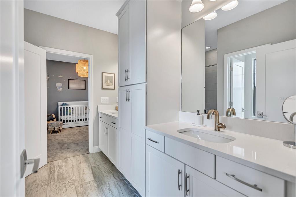 4593 Shoreleaf Loop Valrico, FL 33596 - Photo 21 of 39 a en suite bathroom with a sink and a mirror