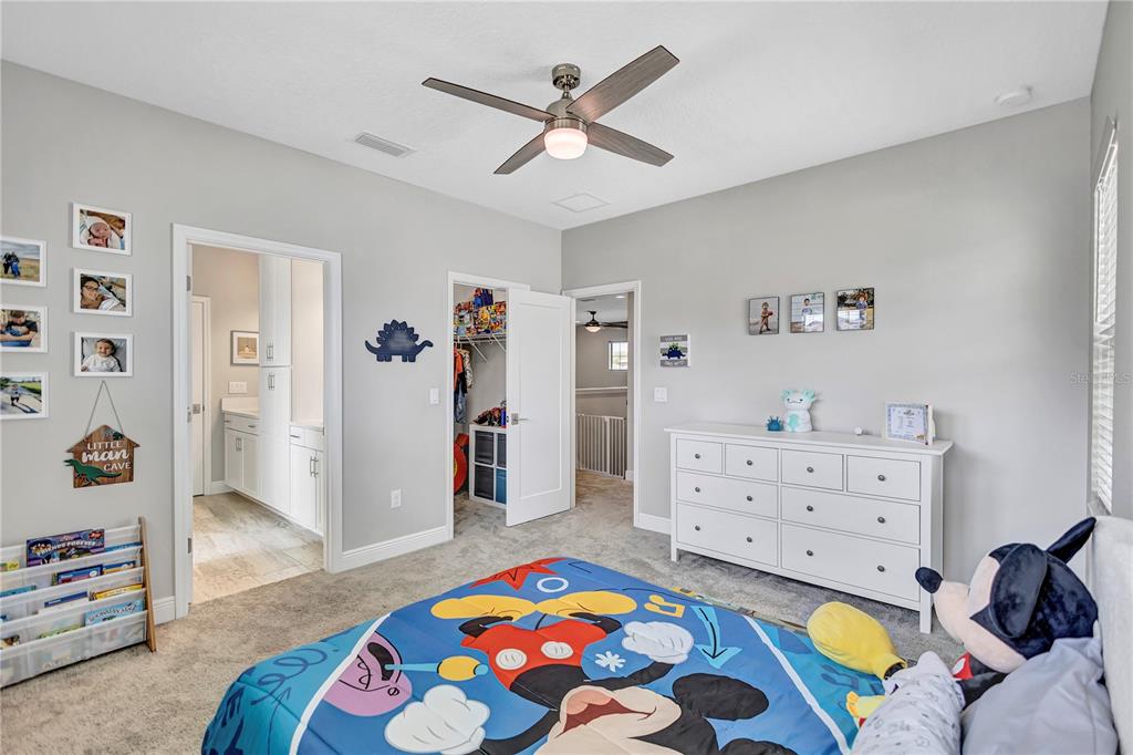 4593 Shoreleaf Loop Valrico, FL 33596 - Photo 23 of 39 a bedroom with a bed and a dresser