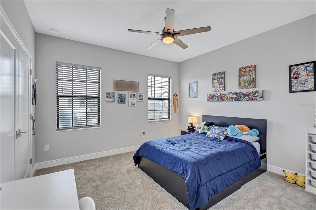 4593 Shoreleaf Loop Valrico, FL 33596 - Photo 24 of 39 a bedroom with a bed and window