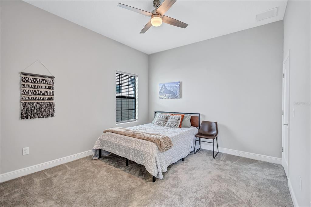 4593 Shoreleaf Loop Valrico, FL 33596 - Photo 28 of 39 a bedroom with a bed and window