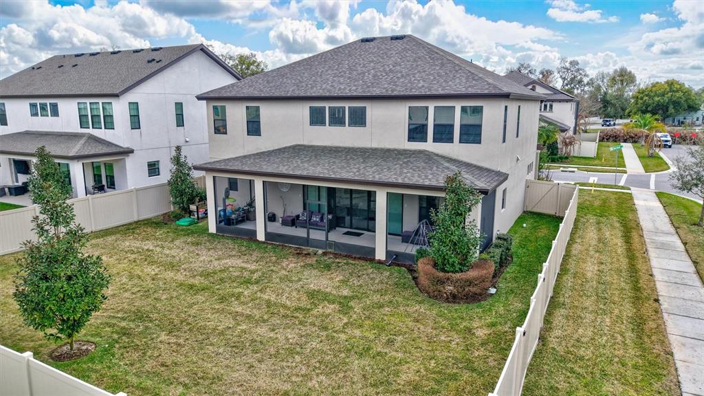 4593 Shoreleaf Loop Valrico, FL 33596 - Photo 36 of 39 a view of a house with a yard patio and a garden