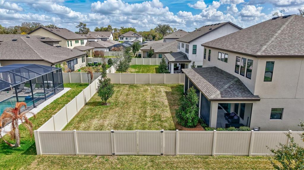 4593 Shoreleaf Loop Valrico, FL 33596 - Photo 37 of 39 a view of a house with a small yard and large trees