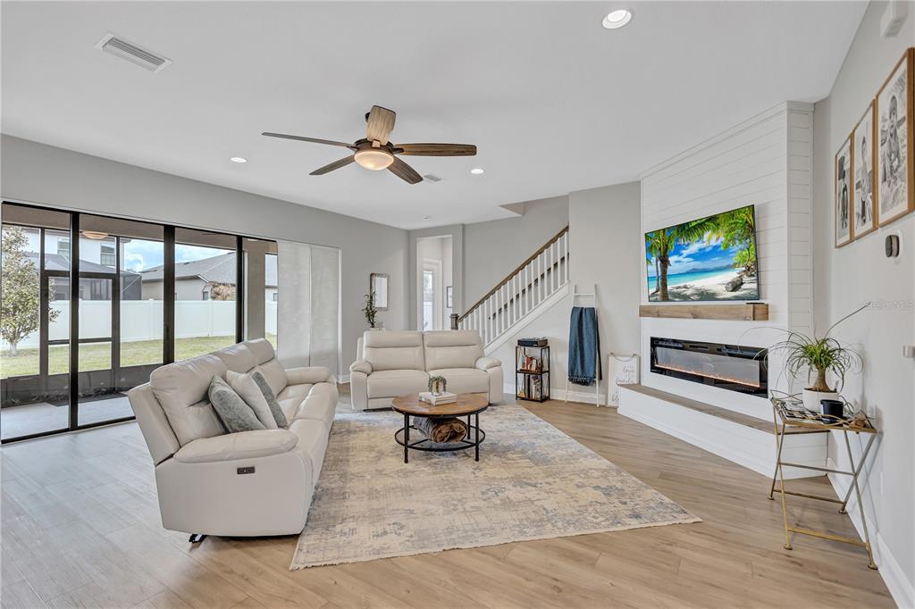 4593 Shoreleaf Loop Valrico, FL 33596 - Photo 6 of 39 a living room with furniture ceiling fan and a rug