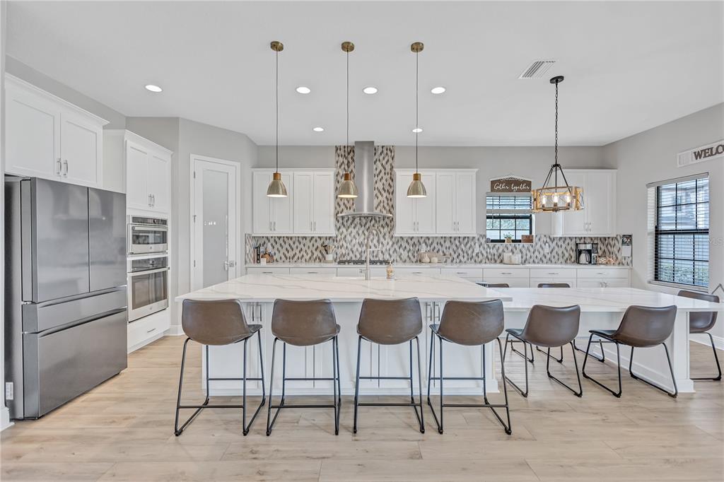 4593 Shoreleaf Loop Valrico, FL 33596 - Photo 7 of 39 a kitchen with a chandelier and refrigerator