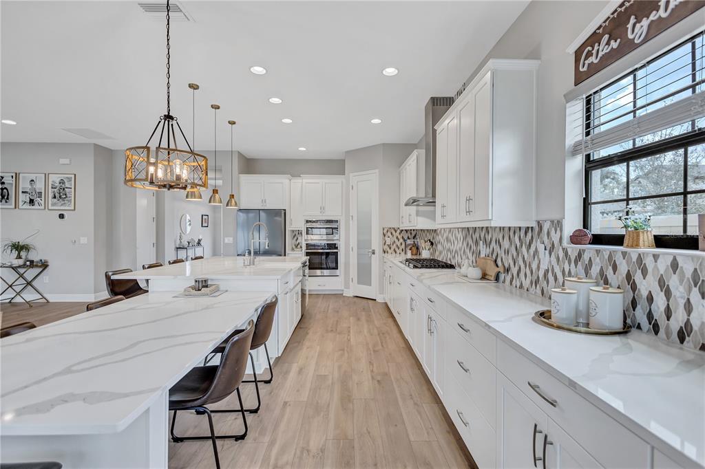 4593 Shoreleaf Loop Valrico, FL 33596 - Photo 8 of 39 a large kitchen with granite countertop lots of counter space and window