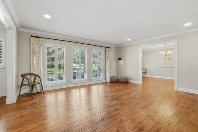 a view of a room with wooden floor and furniture