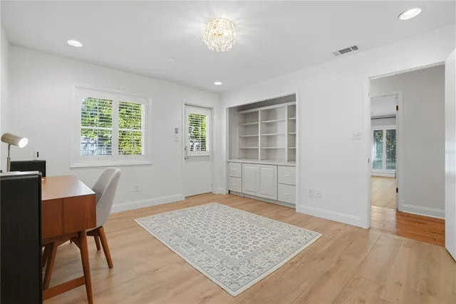 a spacious bedroom with a bed and flat screen tv