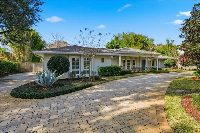 a front view of a house with garden and outdoor seating