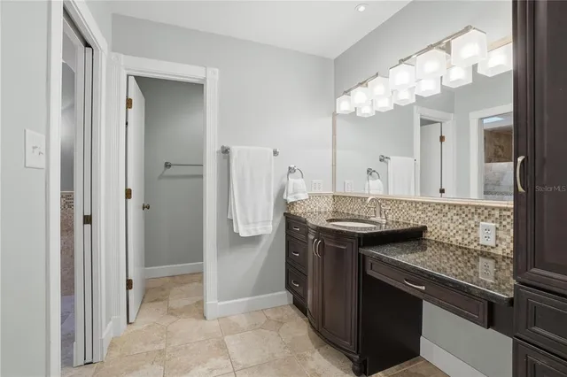 a bathroom with a sink a mirror and a shower