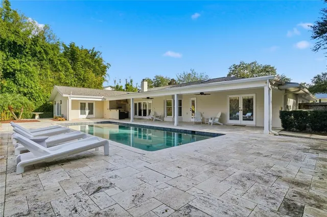 a view of a house with a wooden fence