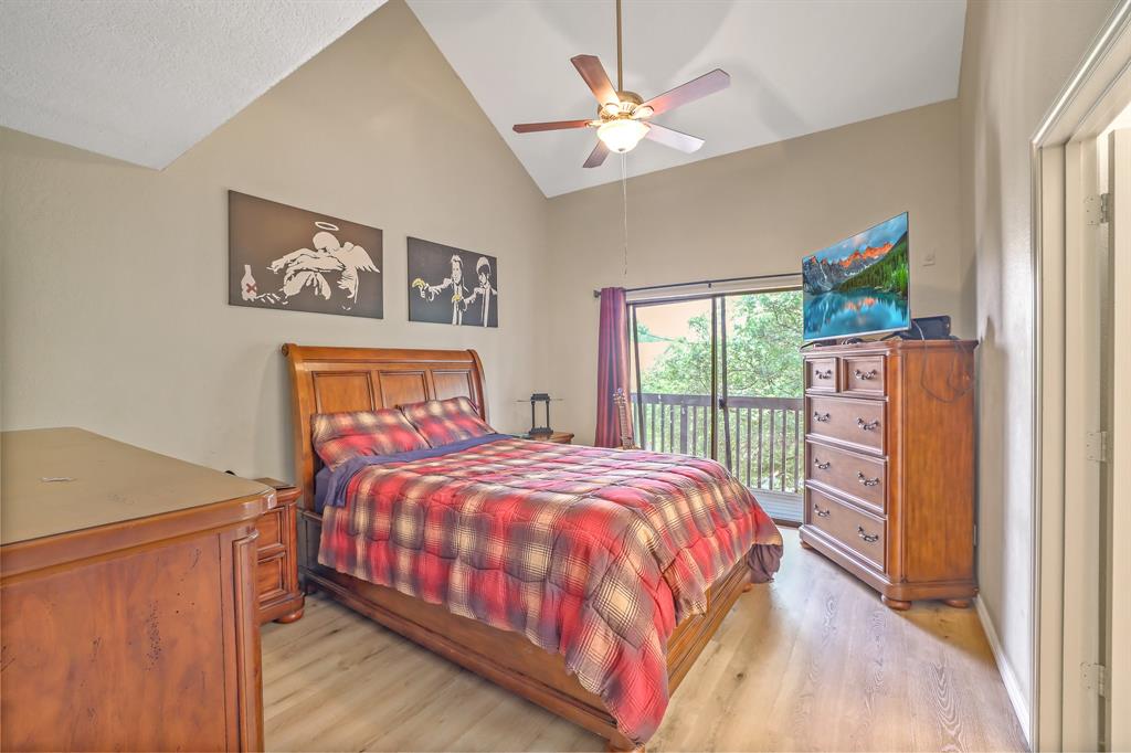 1118 Signal Ridge Place Rockwall, TX 75032 - Photo 11 of 33 a bedroom with a bed a dresser next to a window
