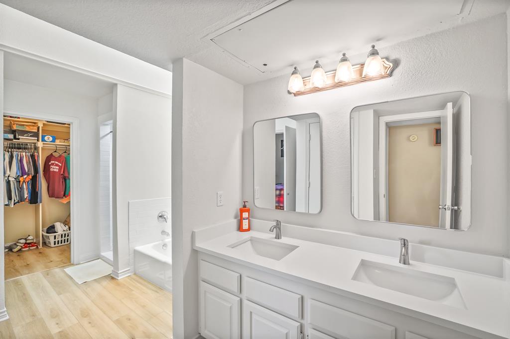 1118 Signal Ridge Place Rockwall, TX 75032 - Photo 15 of 33 a bathroom with a double vanity sink and a mirror
