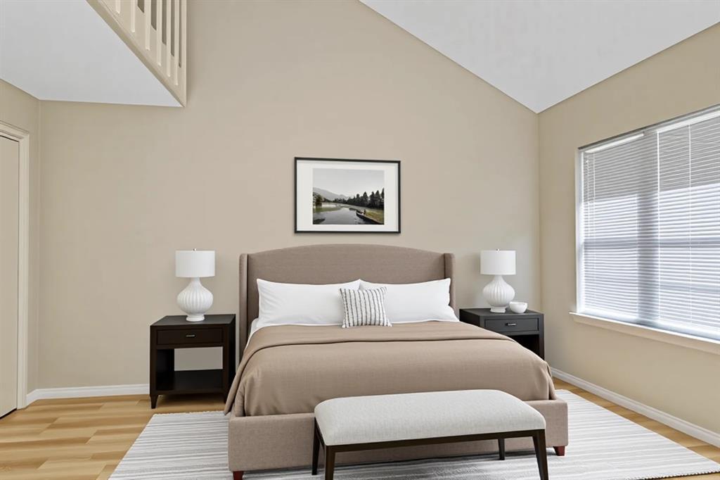 1118 Signal Ridge Place Rockwall, TX 75032 - Photo 19 of 33 a bedroom with a bed and wooden floor