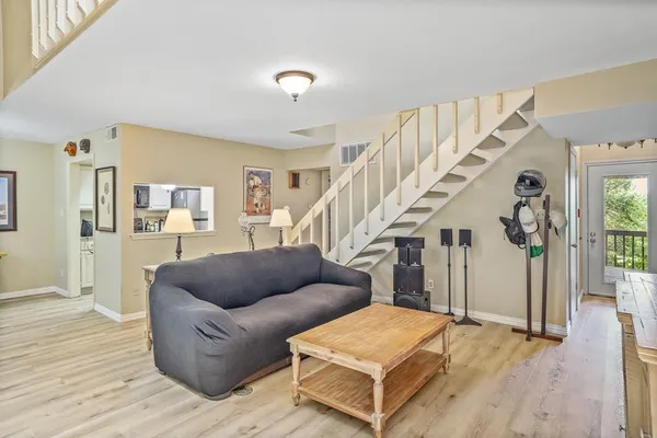 a living room with furniture and wooden floor