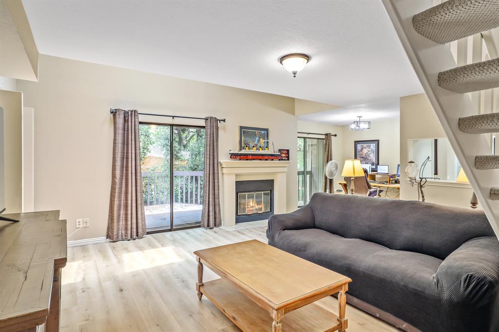 1118 Signal Ridge Place Rockwall, TX 75032 - Photo 4 of 33 a living room with furniture a fireplace and a large window