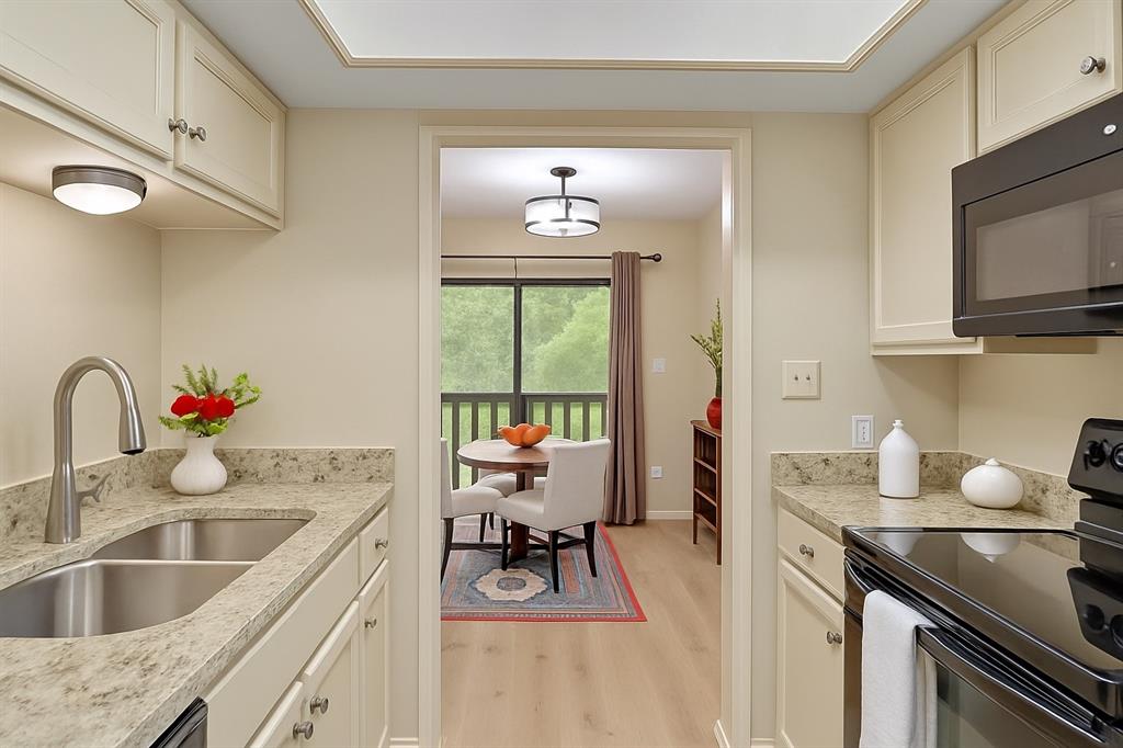 1118 Signal Ridge Place Rockwall, TX 75032 - Photo 8 of 33 a kitchen with a sink stove top oven and microwave