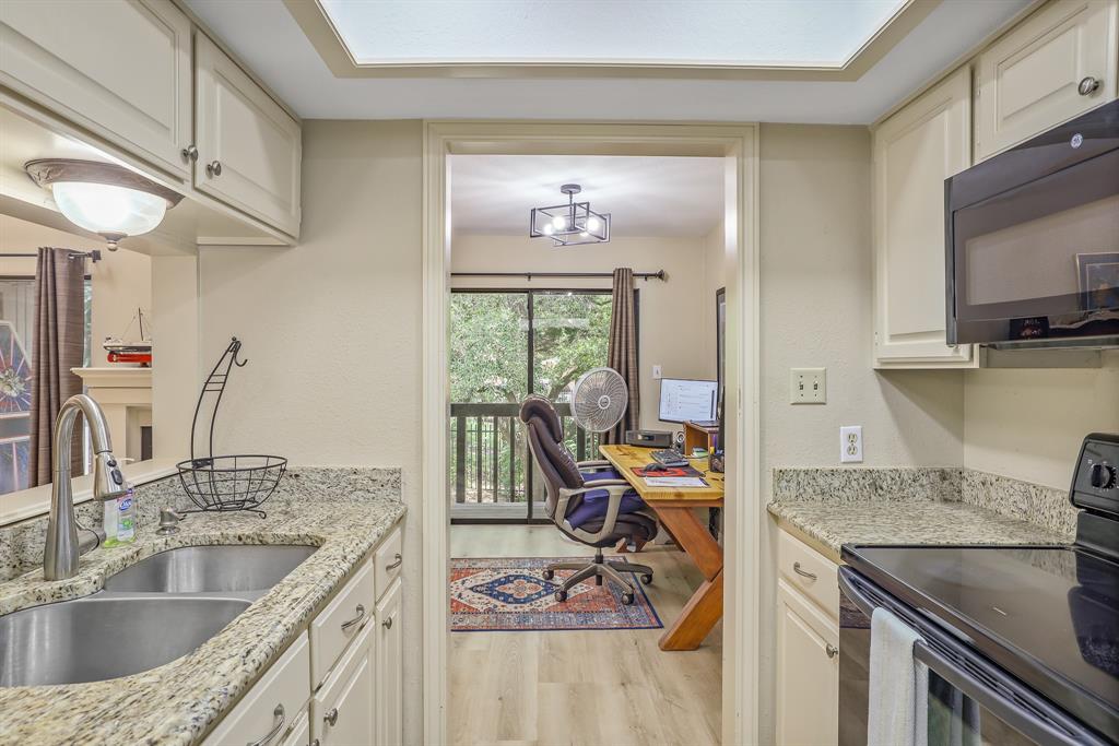 1118 Signal Ridge Place Rockwall, TX 75032 - Photo 9 of 33 a kitchen with a stove a sink and a cabinets