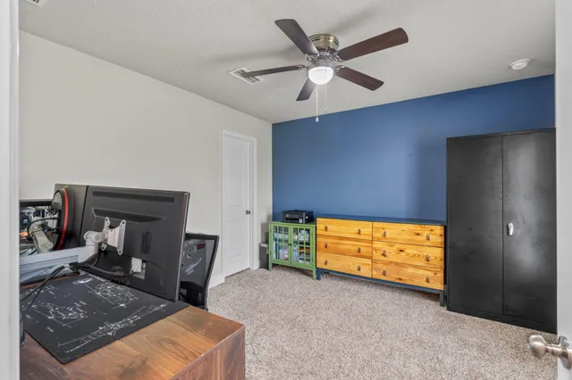 a view of room with window and a ceiling fan