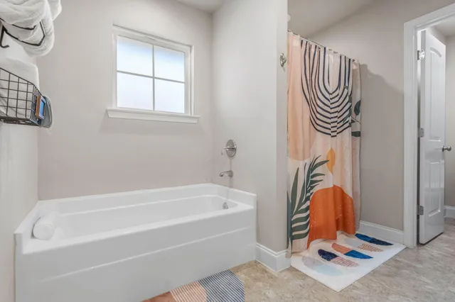 a bathroom with a bathtub and a shower