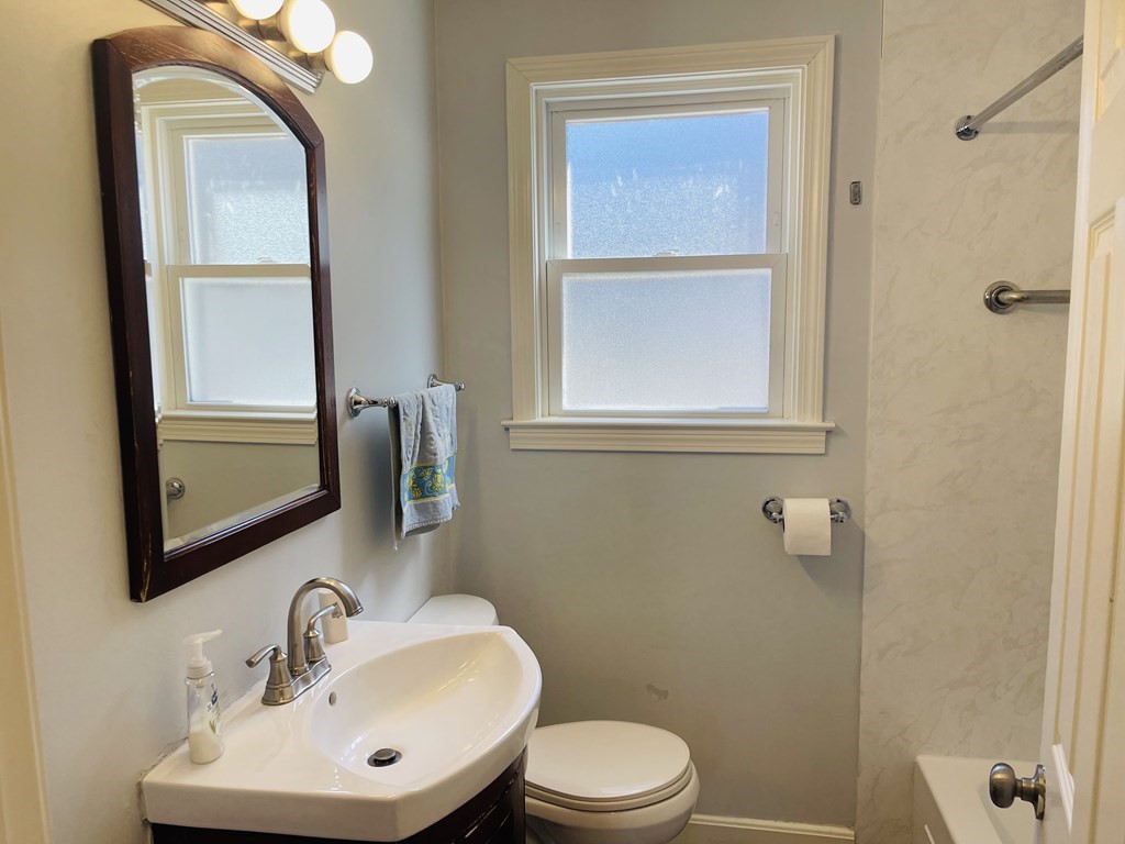 17 Queensview Road Marlborough, MA 01752 - Photo 12 of 41 a bathroom with a toilet a sink a mirror and a window