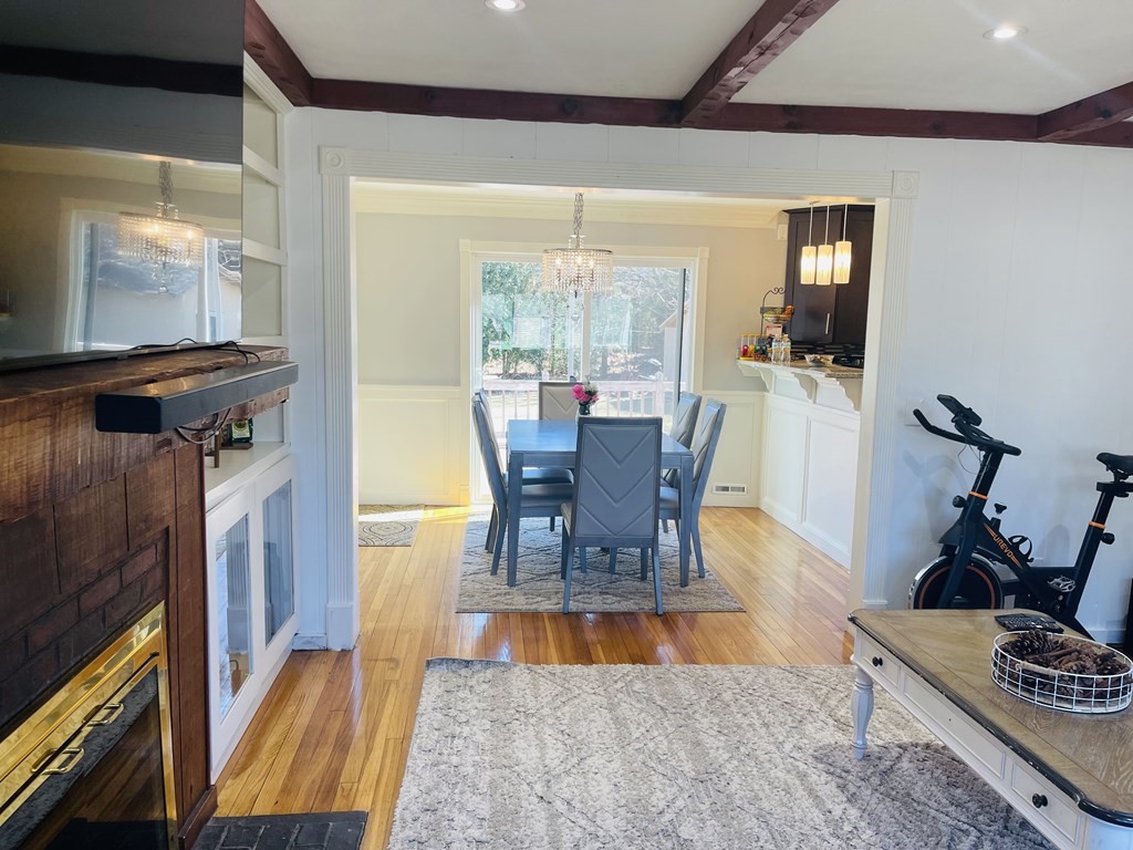 17 Queensview Road Marlborough, MA 01752 - Photo 7 of 41 a living room with furniture a flat screen tv and a floor to ceiling window