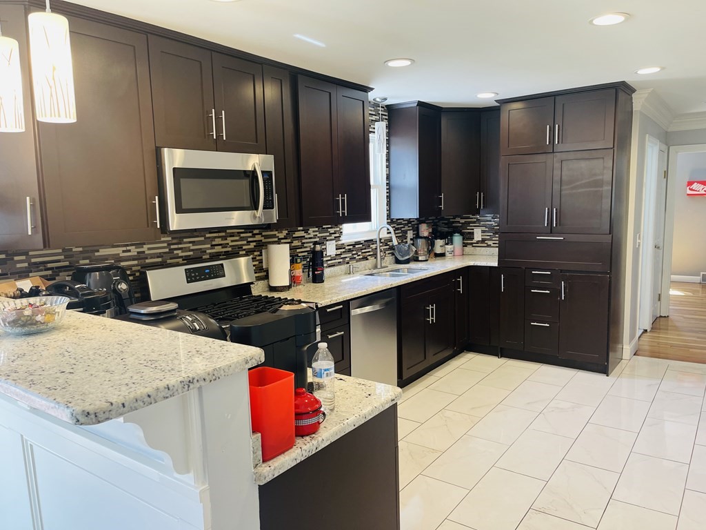 17 Queensview Road Marlborough, MA 01752 - Photo 9 of 41 a kitchen with stainless steel appliances kitchen island granite countertop a refrigerator stove and sink