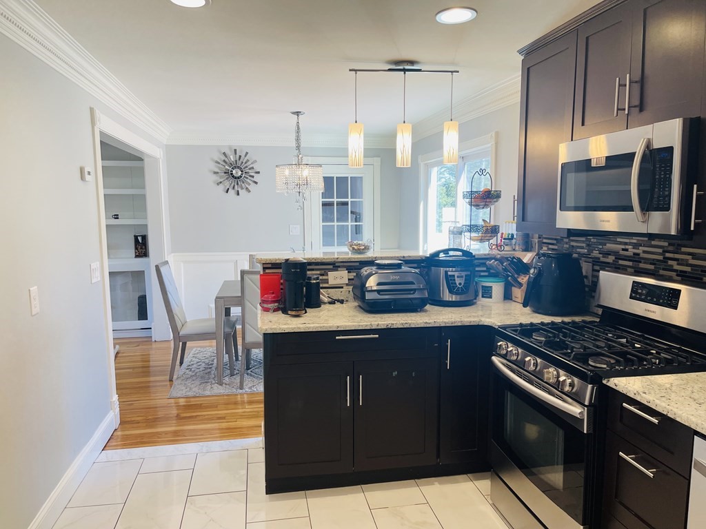 17 Queensview Road Marlborough, MA 01752 - Photo 10 of 41 a kitchen with stainless steel appliances granite countertop a stove a sink and a microwave