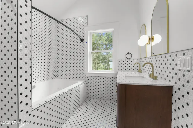 a bathroom with a sink a toilet and a shower