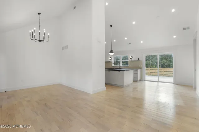 a view of a kitchen with a sink and dishwasher wooden floor