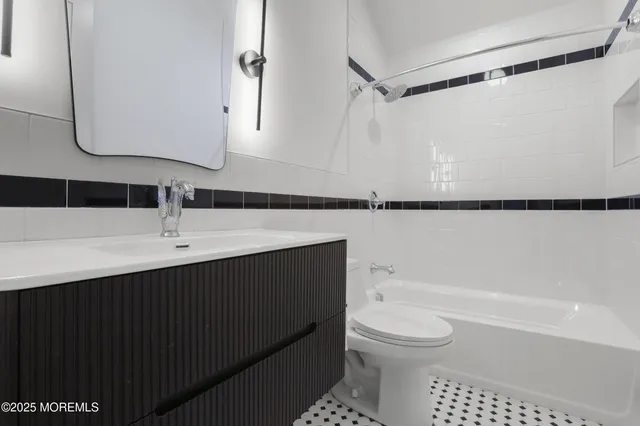 a bathroom with a sink a toilet and a bathtub