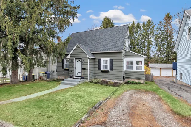 a view of a house with a yard and sitting area