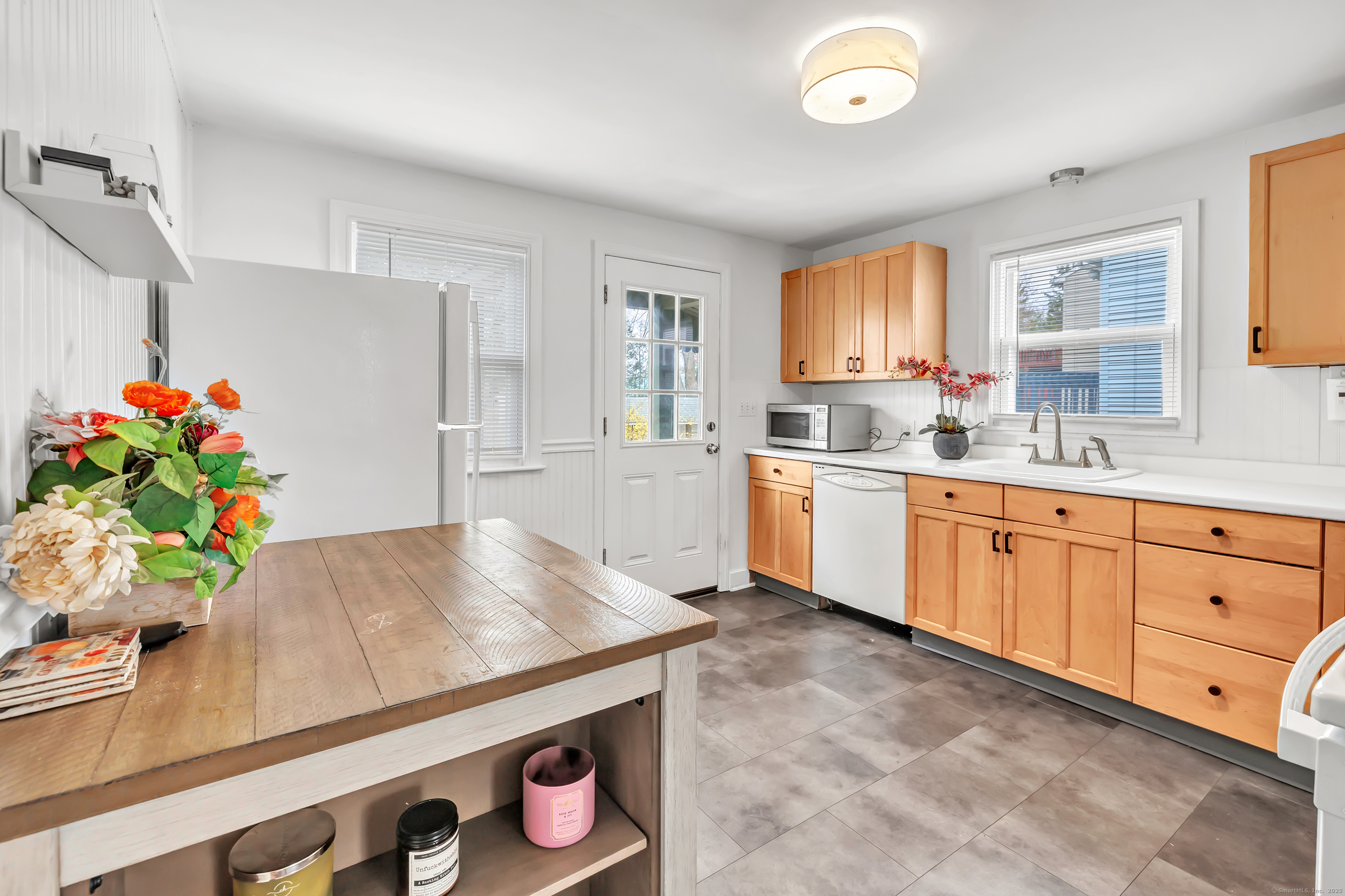 804 Washington Ave Extension Waterbury, CT 06708 - Photo 11 of 35 a kitchen with stainless steel appliances cabinets and a table