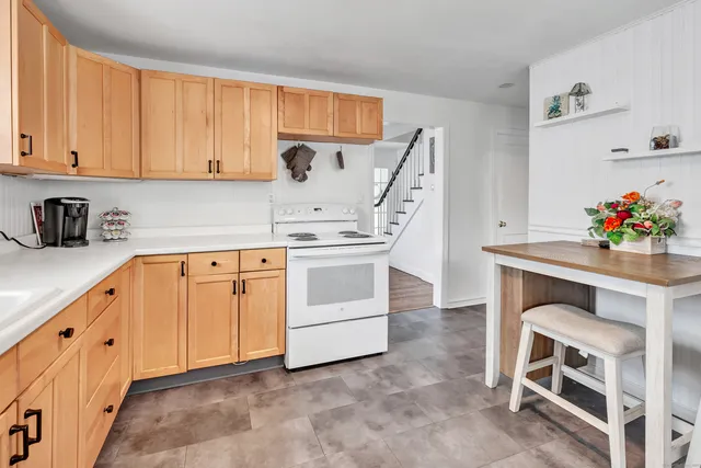 a kitchen with white cabinets and white appliances