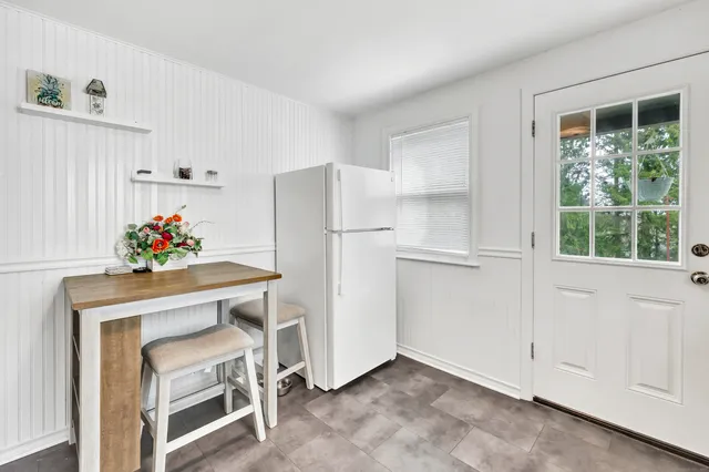 a kitchen with furniture and a window