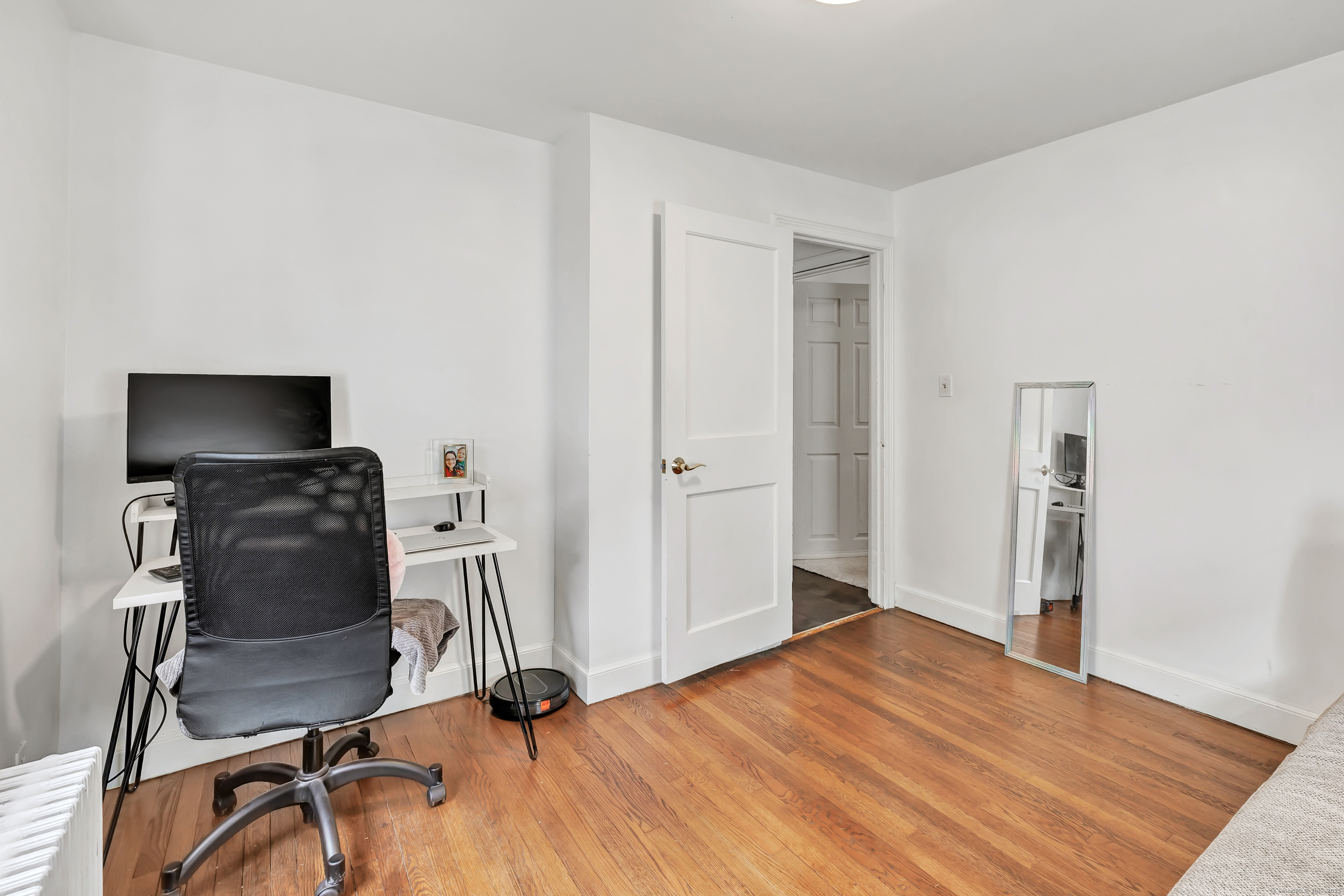 804 Washington Ave Extension Waterbury, CT 06708 - Photo 17 of 35 a view of a workspace with furniture and wooden floor