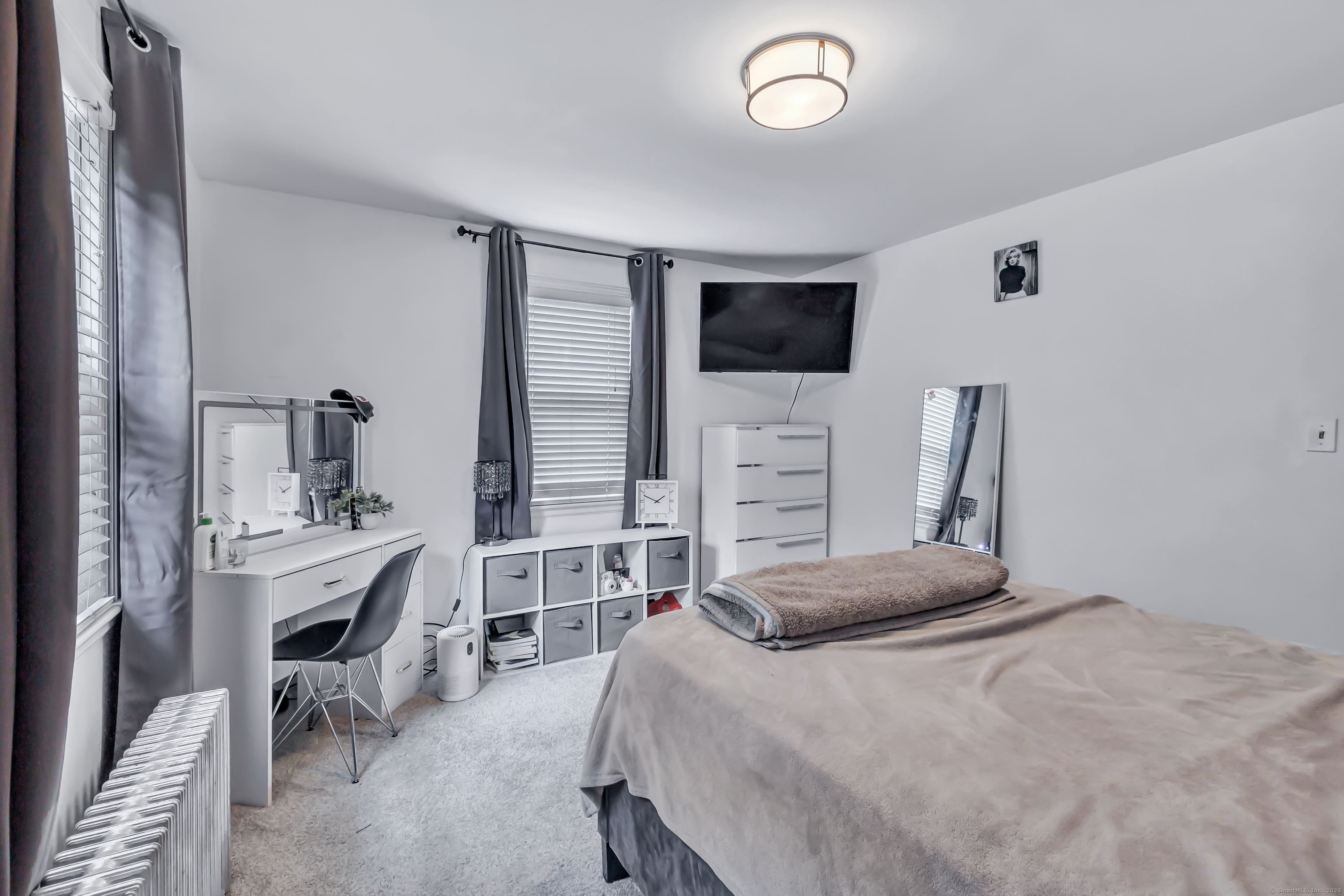 804 Washington Ave Extension Waterbury, CT 06708 - Photo 19 of 35 a bedroom with a bed and a flat screen tv