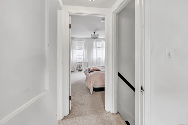 a view of a hallway with closet and couch