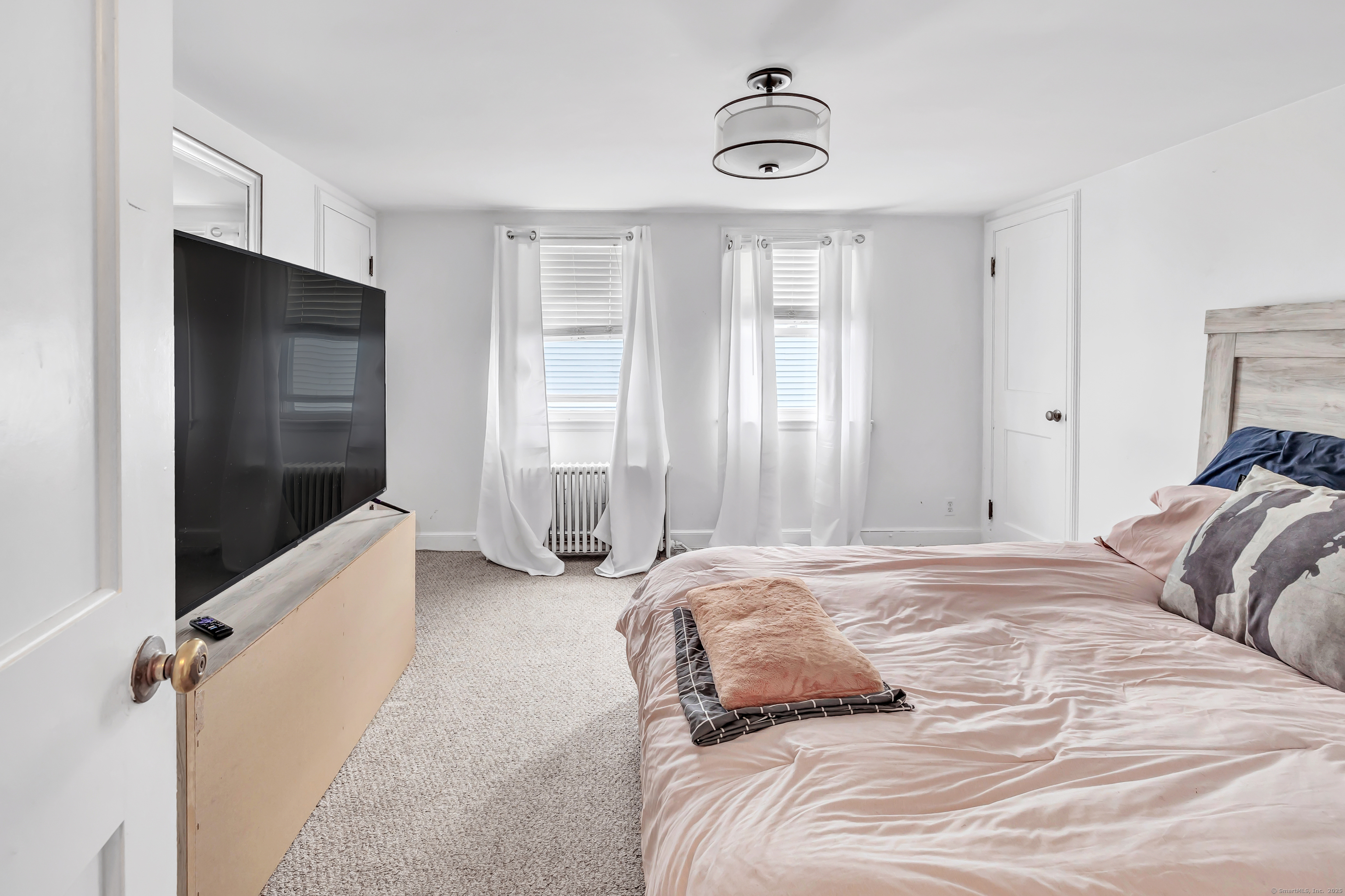 804 Washington Ave Extension Waterbury, CT 06708 - Photo 22 of 35 a bedroom with a bed and a chandelier