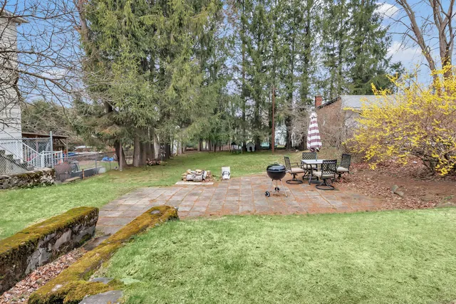 a view of a backyard with sitting area
