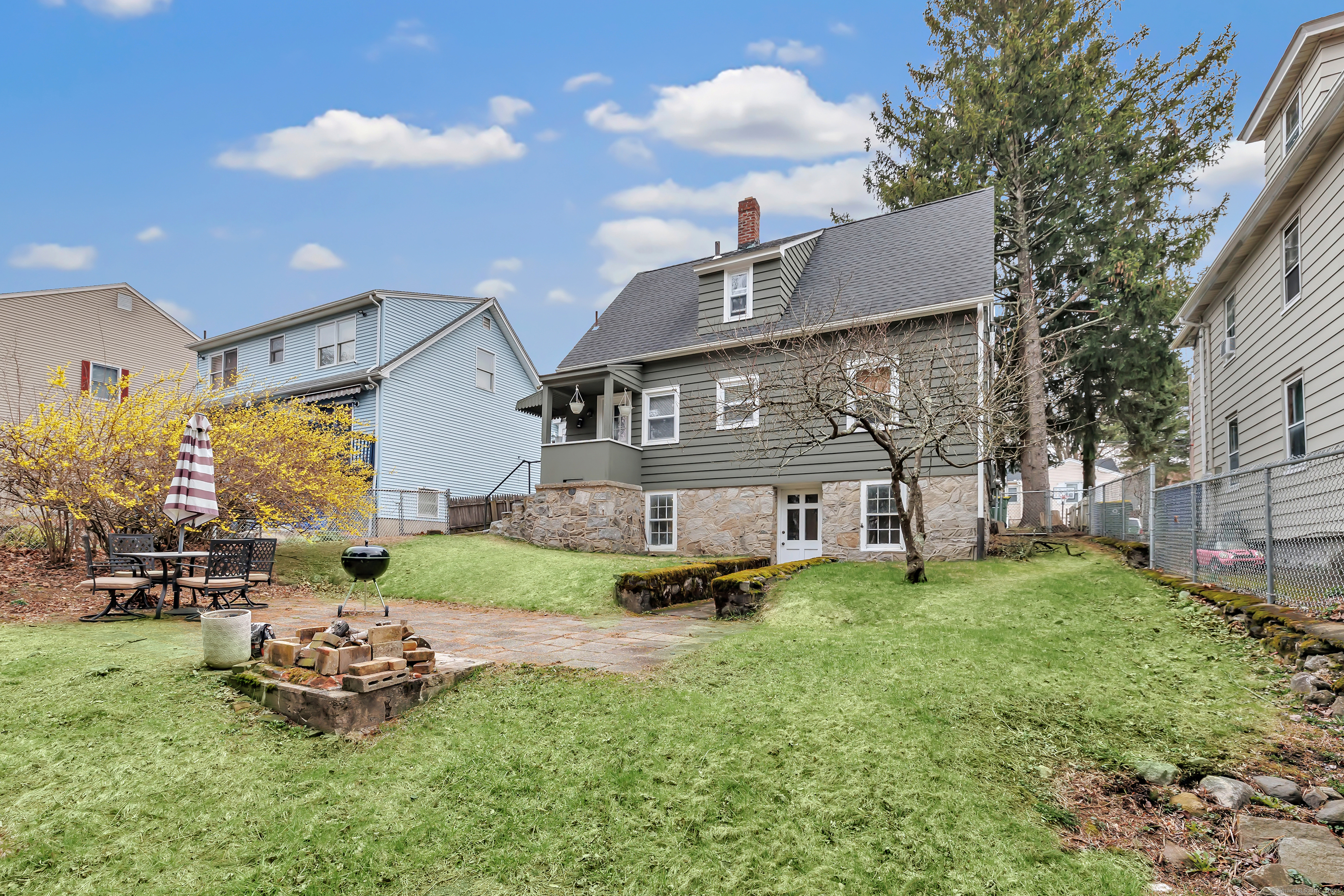 804 Washington Ave Extension Waterbury, CT 06708 - Photo 31 of 35 a front view of a house with a garden and plants