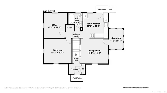 a black and white photo of a bench in a white building